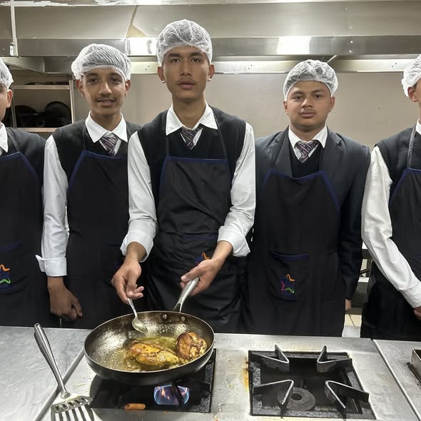 Elite Culinary Student Searing Pan on Commercial Flame